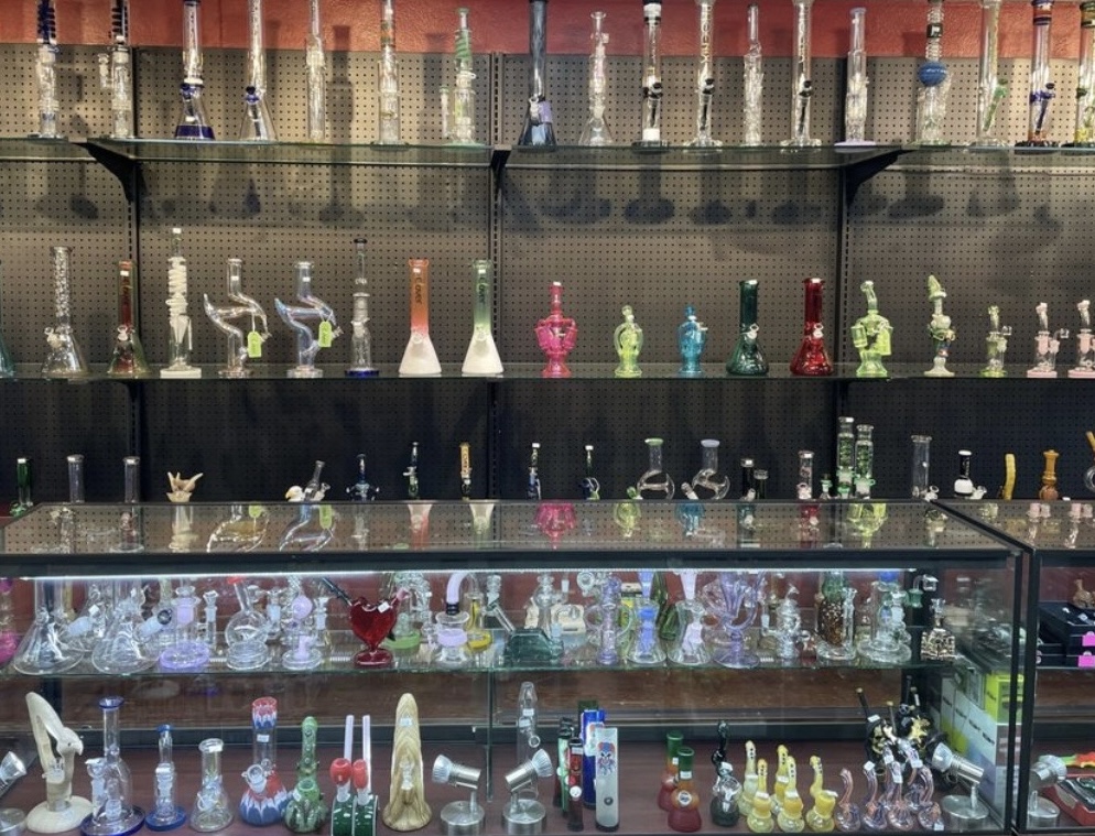Display of glass pipes on illuminated shelves