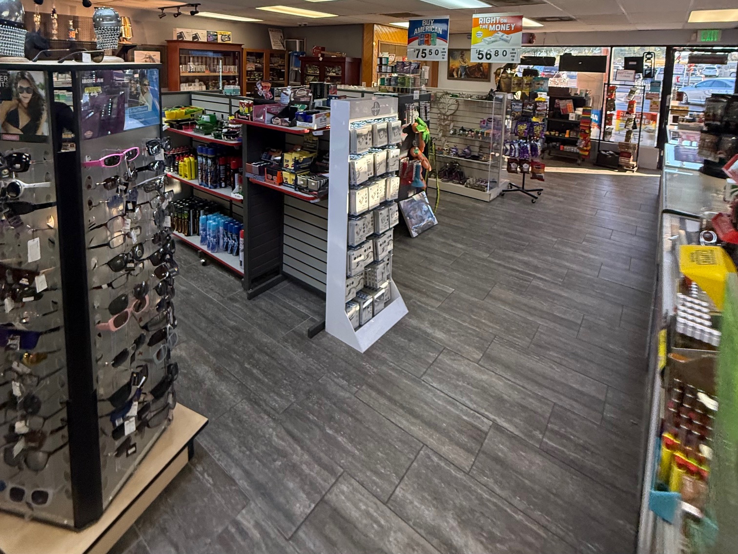Sunglasses and lighter spinner racks in the middle of the store