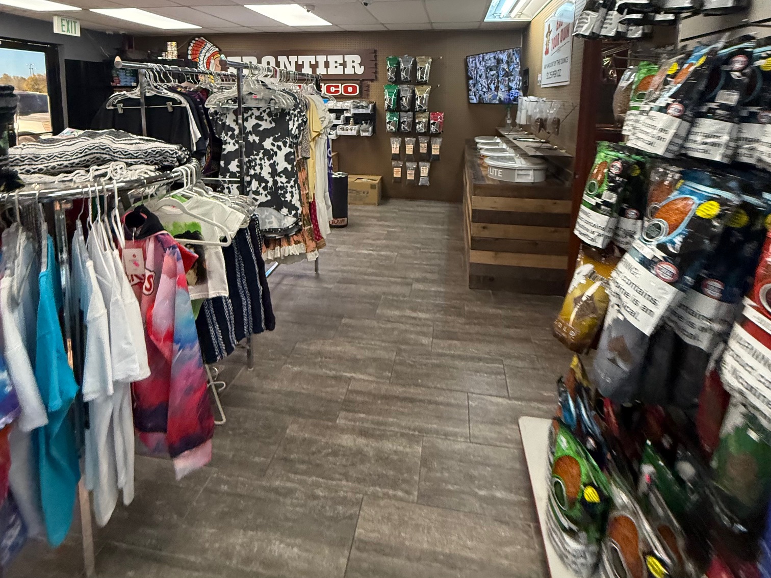 Apparel and tapestry display in the back of the store