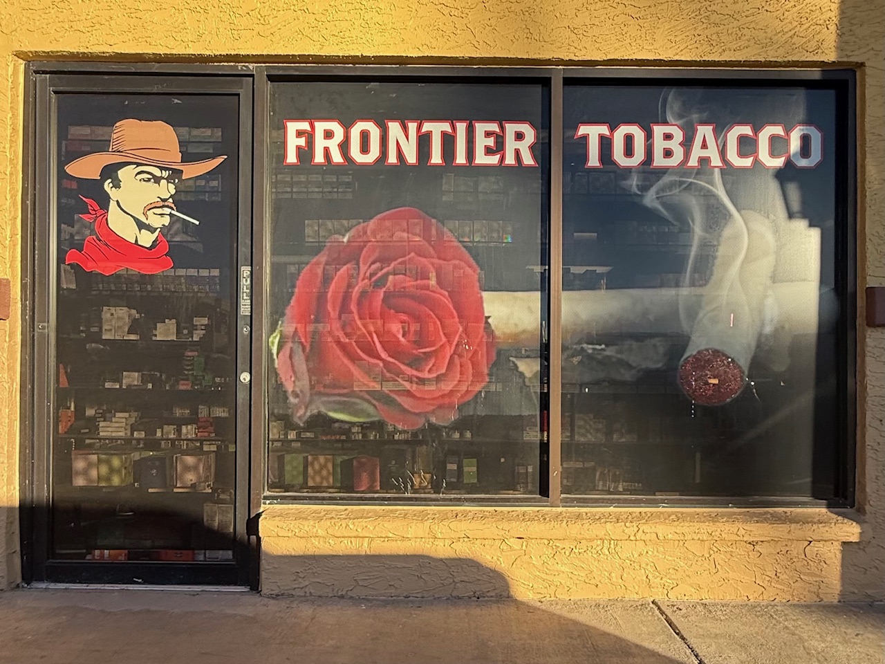 Hand-painted Frontier Tobacco cowboy and rose detail on the window