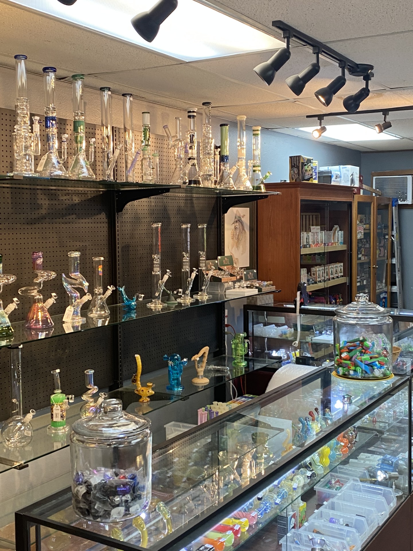 Glass pipe and water pipe display along the back wall
